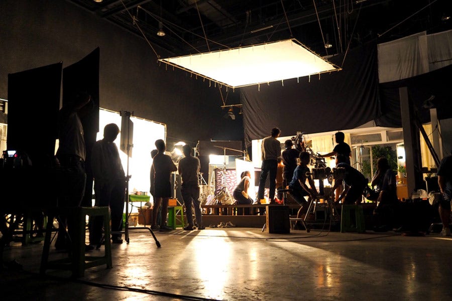 silhouetted shot of film crew on dimly lit set